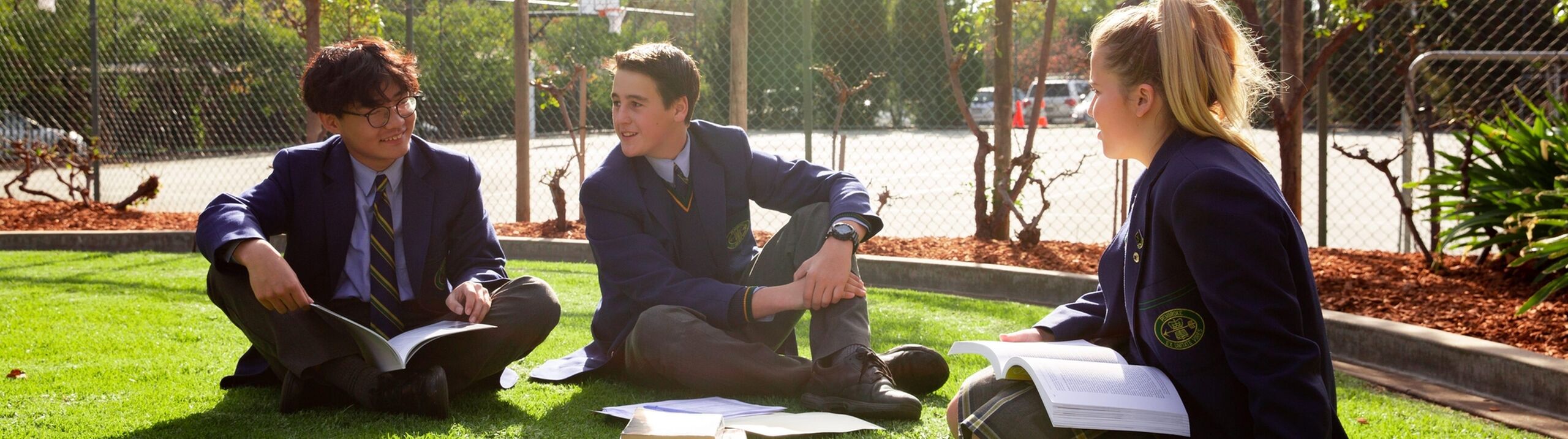 Boarding students sitting outside studying