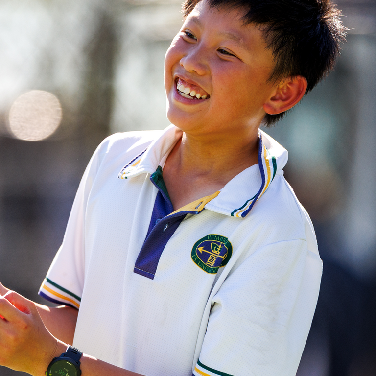 Middle school male playing tennis