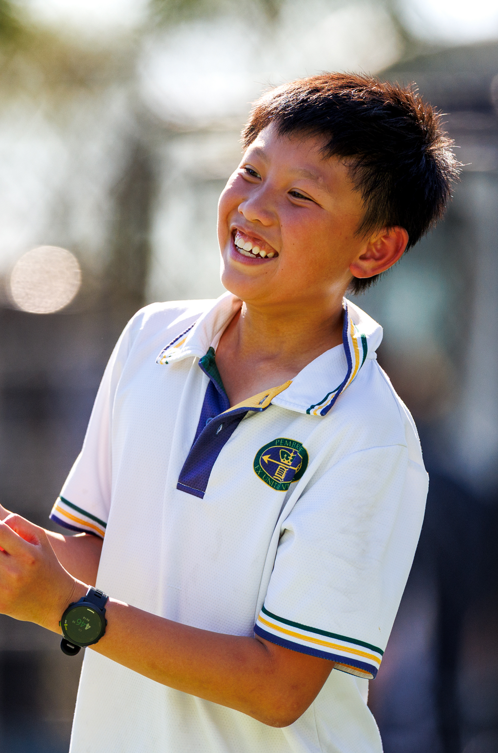 Middle school male playing tennis