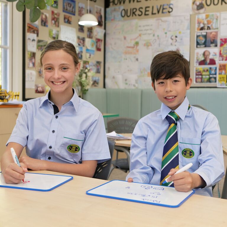 JS boy and girl drawing at desk