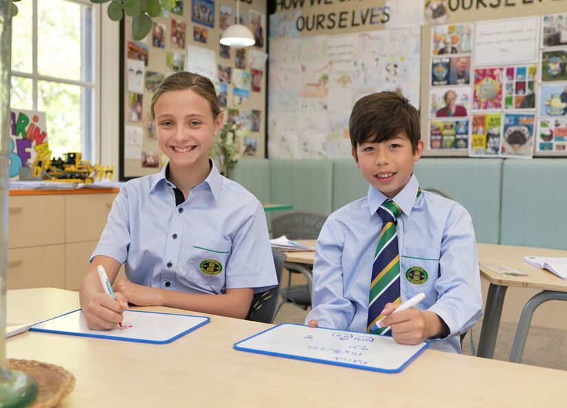 JS boy and girl drawing at desk