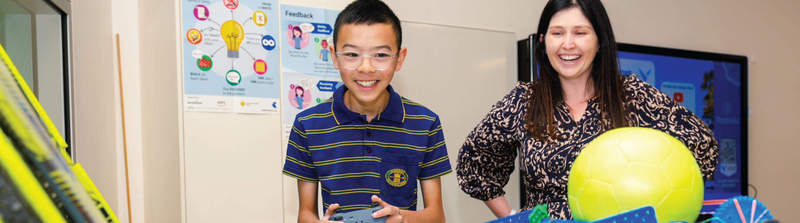 Teacher with student in robotics class